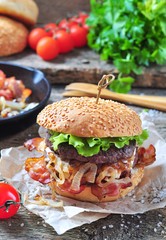 juicy homemade double burger beef with fried onions on a wooden background
