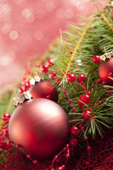 Christmas background - baubles and branch of spruce tree