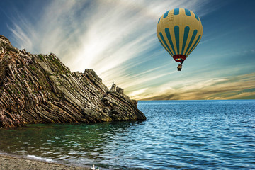 Hot air balloon over summer beach, rock, Budva, Montenegro