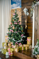 Beautifully decorated Christmas tree with many presents under it.