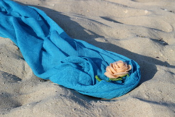Fototapeta premium Textile handmade rose on a blue pareo