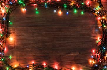 Christmas Greeting Card - Frame of Garland on a wooden surface