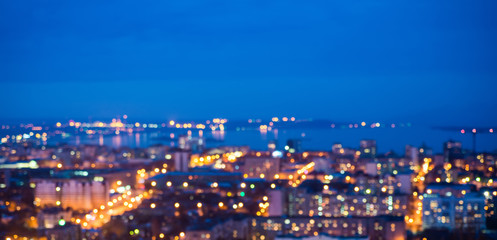 defocused abstract city lights in the twilight with river, refle