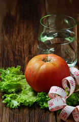Concept of diet food: vegetable, water and measuring tape