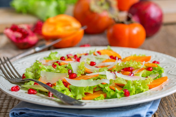 Delicious salad with persimmon. Healthy food.