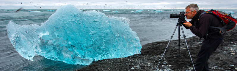 Photographer at Jokulsarlon, glacier lagoon, Iceland
