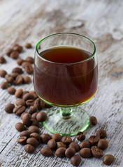 Glass of coffee liquor and coffee beans