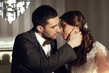 beautiful couple, groom and bride wear wedding clothes,embracing  in bedroom