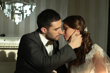 beautiful couple, groom and bride wear wedding clothes,embracing  in bedroom