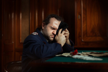 Man sitting at the table crying.