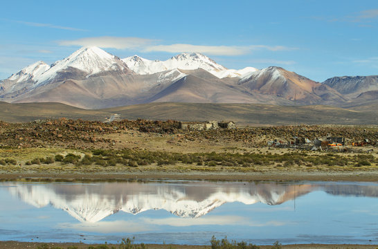 Snow capped high mountains reflected in Lake Chungara