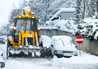 Yellow Bulldozer Snow Plowing Street In Urban Area