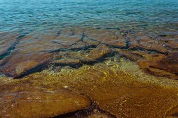 Rock beach and clear blue water