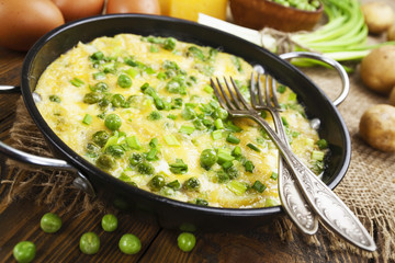 Omelette with green peas, potatoes and cheese