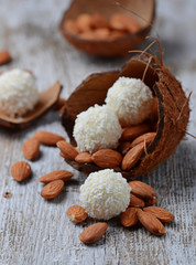 Coconut candies with almonds in coconut shell