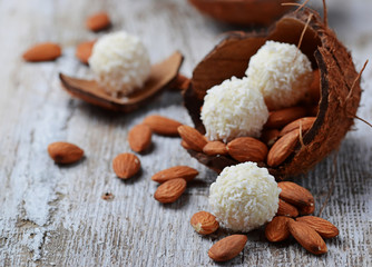 Coconut candies with almonds in coconut shell