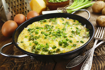 Omelette with green peas, potatoes and cheese