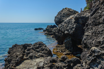 Rock beach and clear blue water