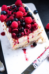 Homemade Pavlova with berry fruits on serving board