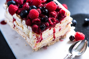 Homemade Pavlova with berry fruits on serving board