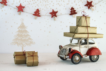 Christmas holiday concept with gift boxes on toy car