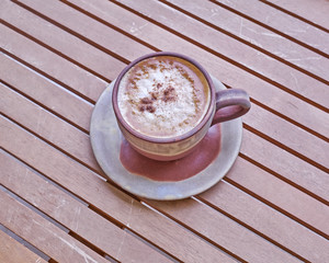 capuccino coffee in brown cup, cinnamon assorted