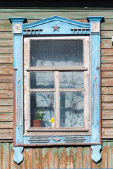 Fototapeta na wymiar Carved window in old National russian wooden house