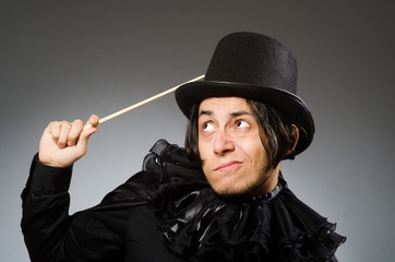 Funny magician wearing cylinder hat