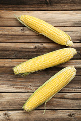 Corns on a brown wooden background