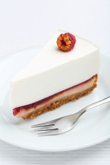 Fresh raspberry cheesecake on white plate
