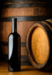 red wine bottle on wooden background