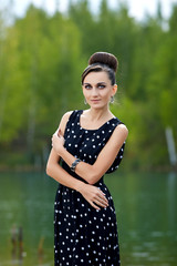 beautiful retro woman in vintage clothes at the lake