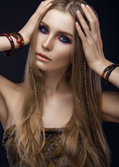 Beautiful fashion girl with bracelets boho style. Beauty face, bright trendy makeup