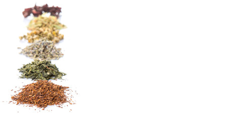 Dried herbal tea leaves, lavender, rooibos, chamomile, linden flower, hibiscus, Japanese green tea over white background