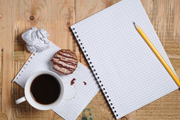 Coffee with cookie and notepad