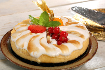 Pudding cake with fruit on a wooden background