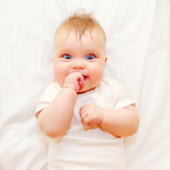 Happy baby sucking his finger