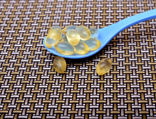 Vitamin E supplement on Spoon close up