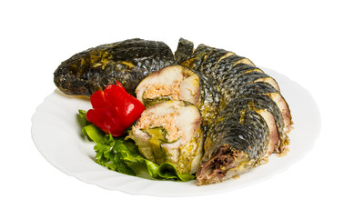baked gefilte fish with greens on the plate, isolated