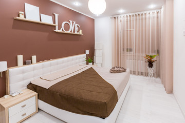 Modern minimalism style bedroom interior in light warm tones