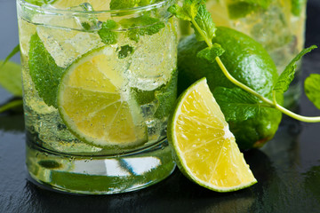 Fototapeta na wymiar Mojito cocktail with fresh limes, mint and ice, selective focus