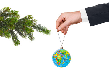 Hand with earth and Christmas tree