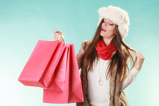 Woman with bags shopping. Winter fashion.
