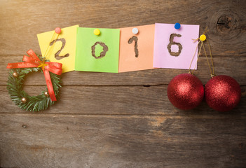 New year 2016 of burned in papernote on a wooden background