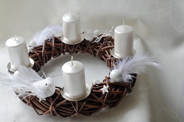 Dark brown wicker-work hand made advent wreath with white candles and doves