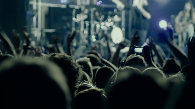Slow motion big crowd at concert cheering clapping hands