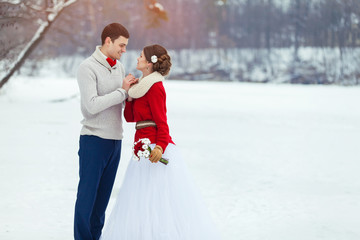 Bride and groom in winter forest