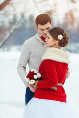 Bride and groom in winter forest