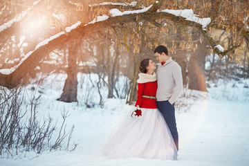 Bride and groom in winter forest
