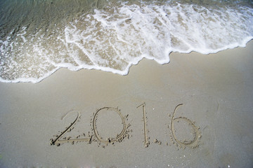  Happy New Year 2016 concept on the sea beach